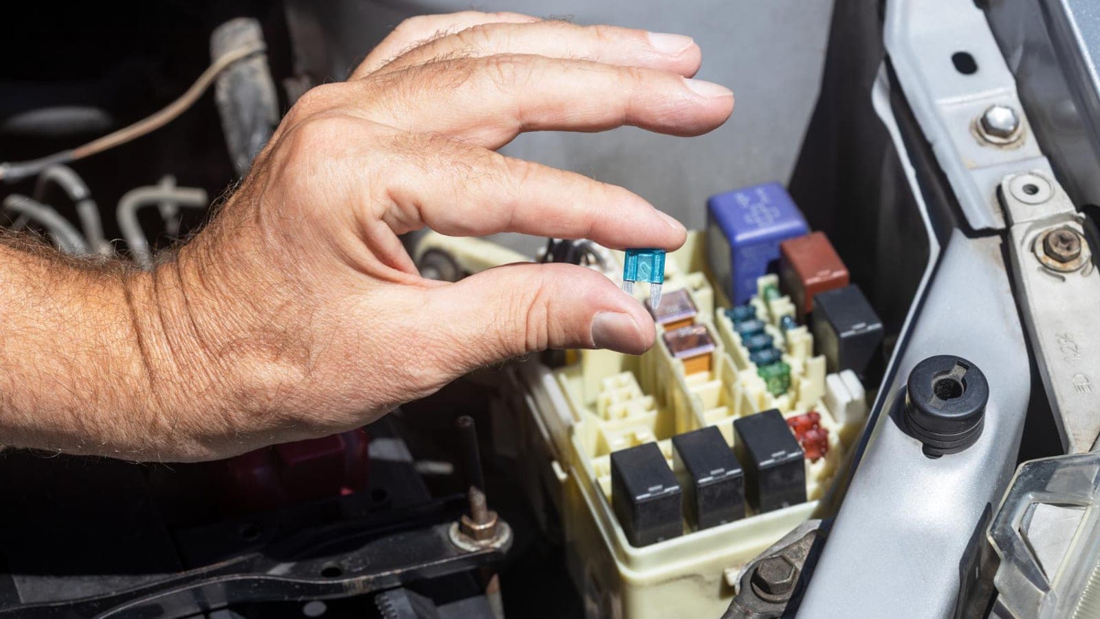 Vehicle fuse box being inspected